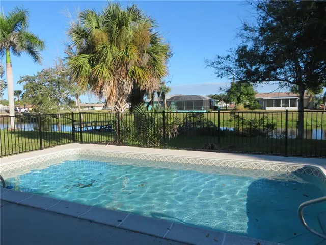 a view of swimming pool with outdoor space and lake view