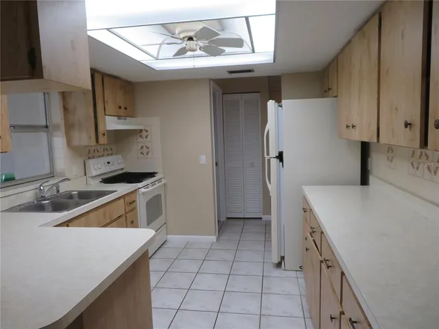 a kitchen with a sink a stove and refrigerator