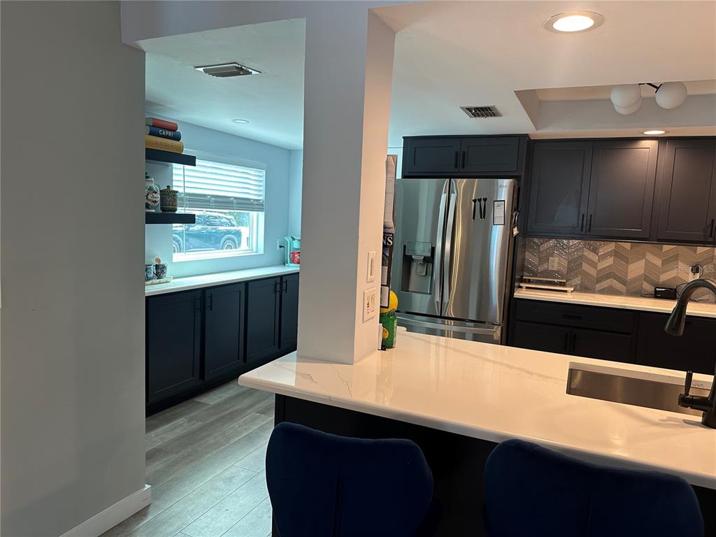 9781 West Halls River Road Homosassa, FL 34448 - Photo 14 of 59 a kitchen with stainless steel appliances kitchen island granite countertop a refrigerator and a sink
