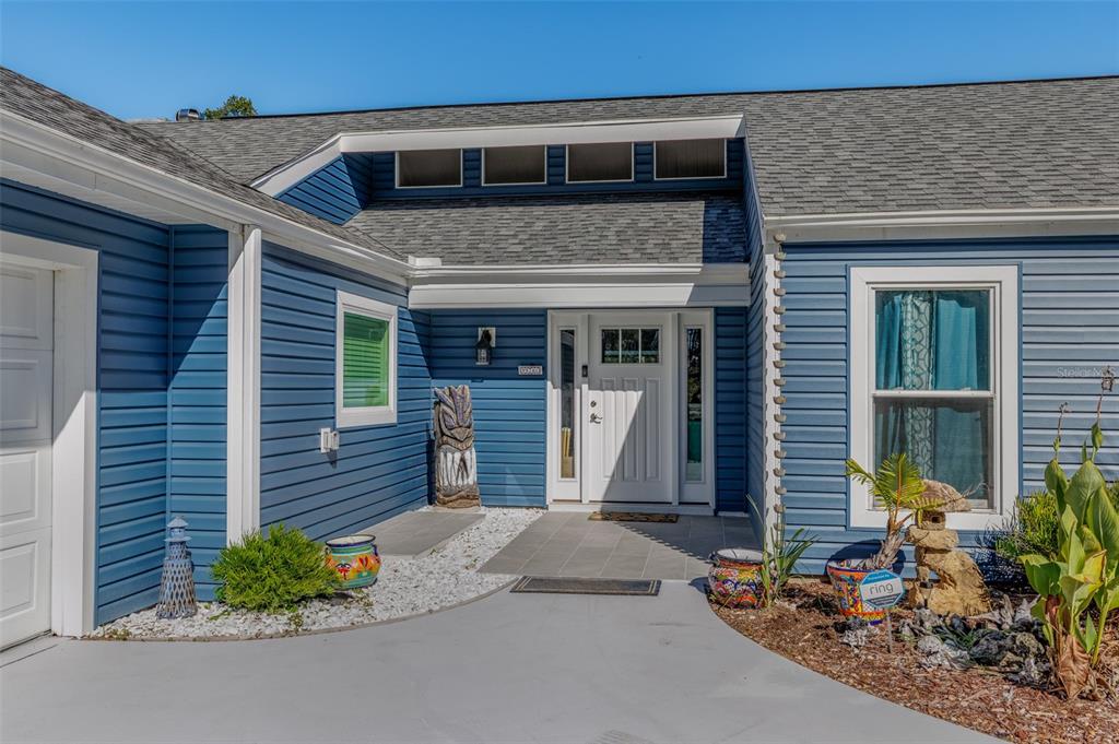 9781 West Halls River Road Homosassa, FL 34448 - Photo 2 of 59 a front view of a house with garden