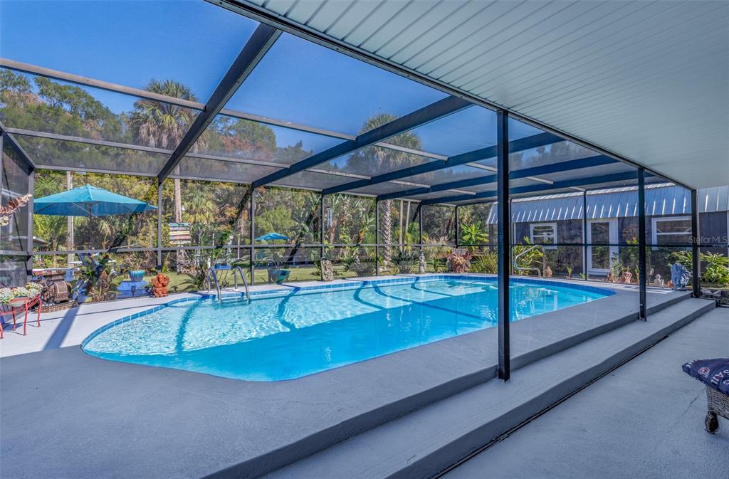 9781 West Halls River Road Homosassa, FL 34448 - Photo 29 of 59 a view of a backyard with a small deck and a backyard