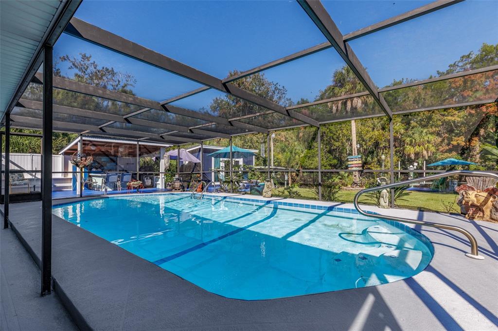 9781 West Halls River Road Homosassa, FL 34448 - Photo 30 of 59 a view of a swimming pool with a patio