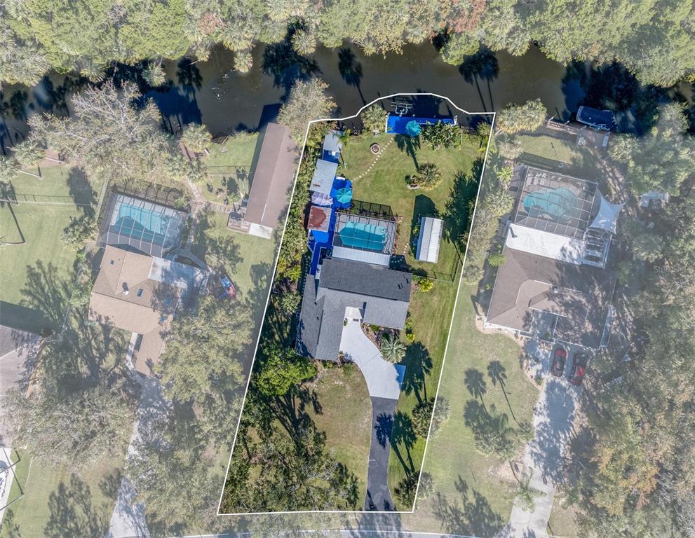 9781 West Halls River Road Homosassa, FL 34448 - Photo 3 of 59 an aerial view of houses with outdoor space