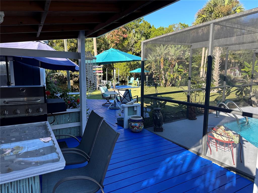 9781 West Halls River Road Homosassa, FL 34448 - Photo 32 of 59 a view of a chairs and table in the patio and a patio