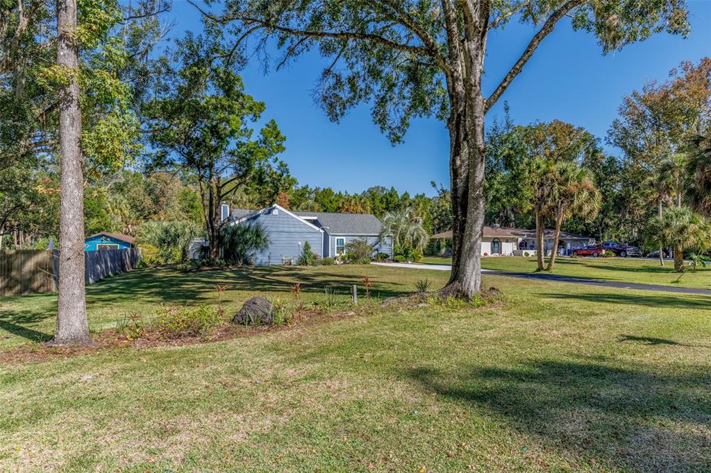 9781 West Halls River Road Homosassa, FL 34448 - Photo 45 of 59 a view of a fountain in the yard with large trees