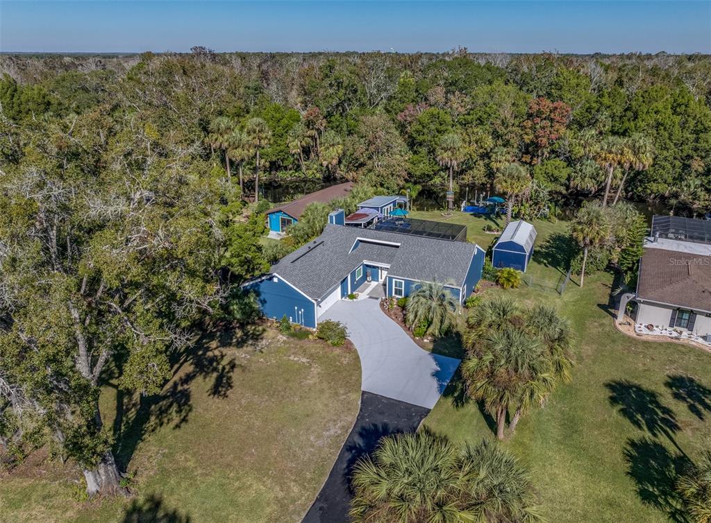 9781 West Halls River Road Homosassa, FL 34448 - Photo 54 of 59 an aerial view of a house with a yard