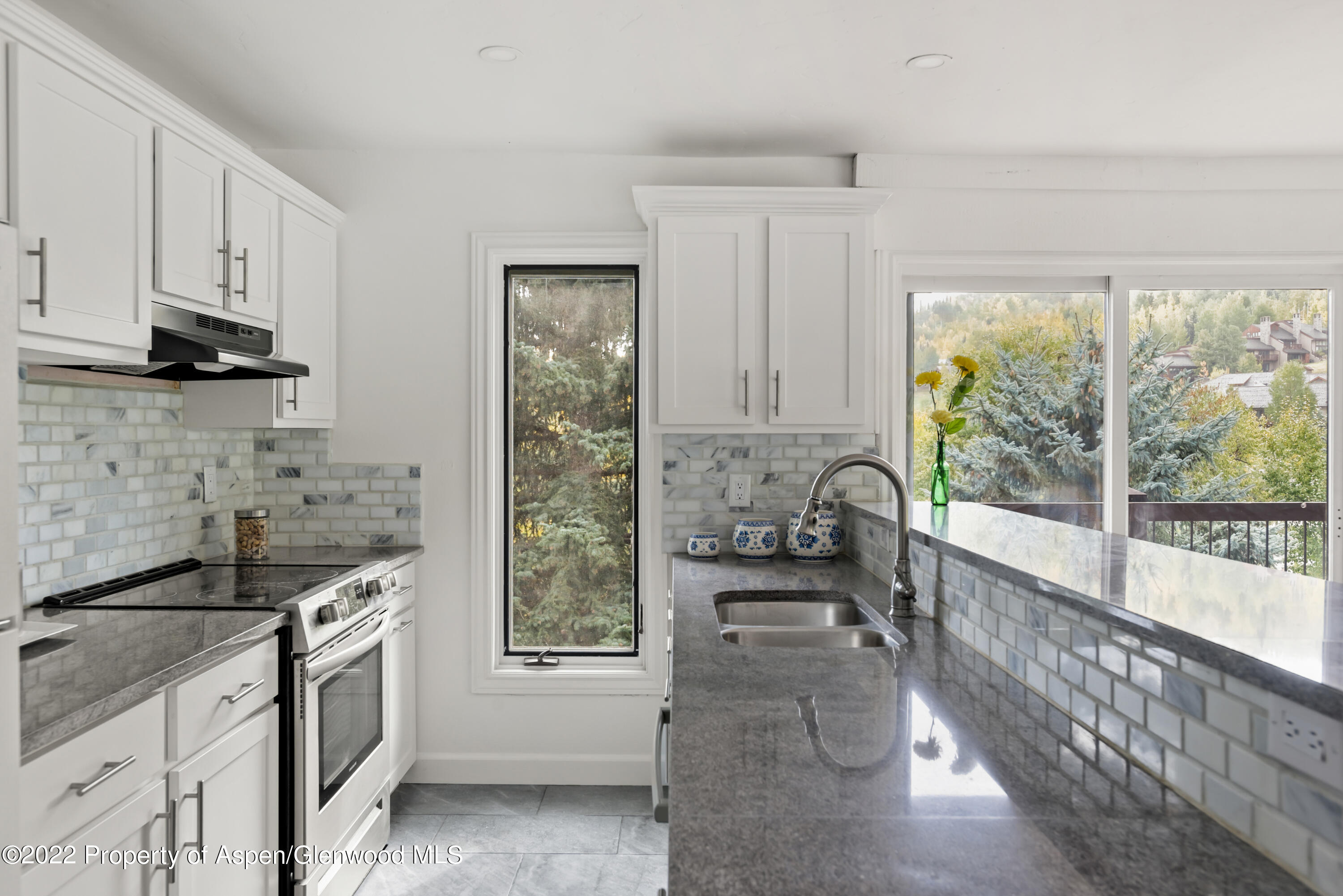 a kitchen with granite countertop a stove a sink and a granite counter tops