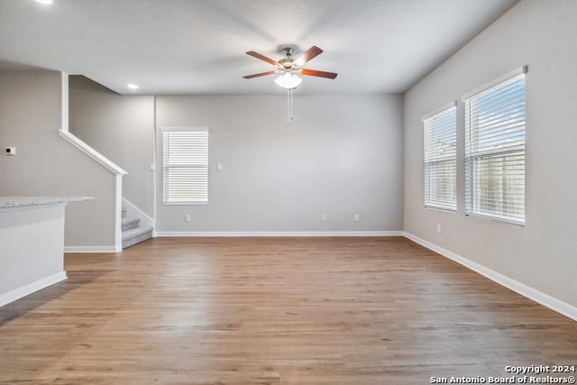 3921 Abbott Pass, Unit 102 St. Hedwig, TX 78152 - Photo 9 of 17 a view of an empty room with wooden floor and a window