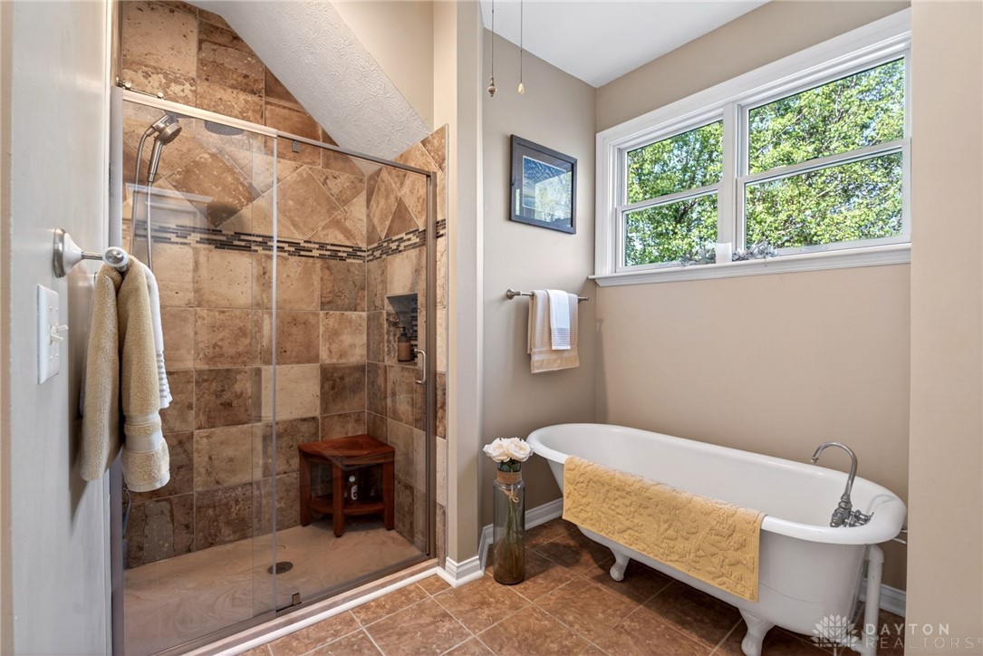 330 South Alpha Bellbrook Road Bellbrook, OH 45305 - Photo 43 of 87 This bathroom features a spacious shower and a charming clawfoot tub for ultimate relaxation.