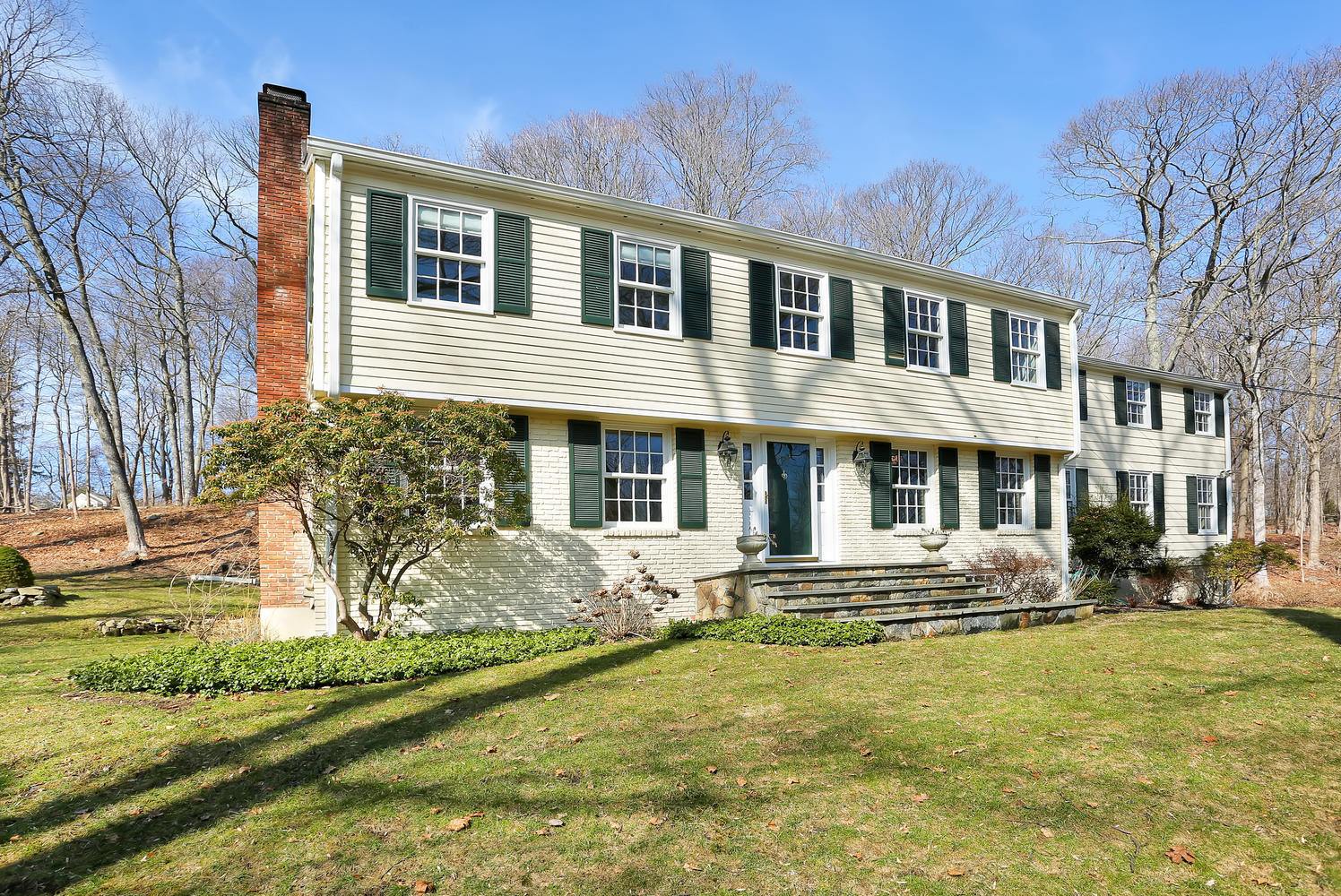 62 Salem Road New Canaan, CT 06840 - Photo 1 of 17 a front view of a house with garden