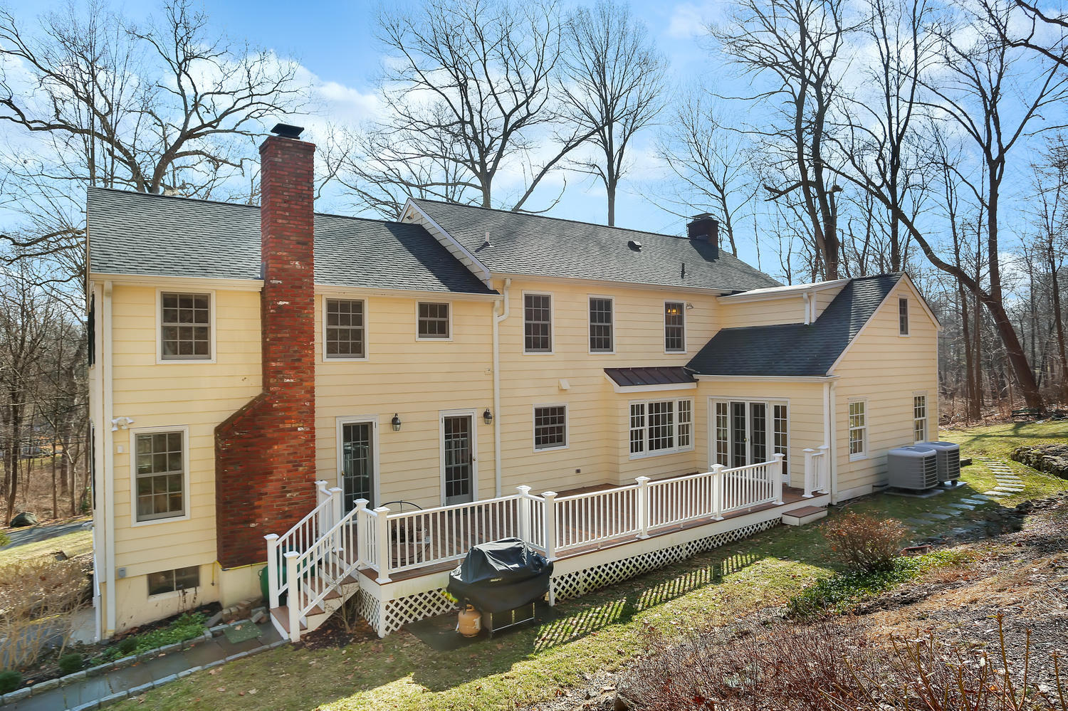 62 Salem Road New Canaan, CT 06840 - Photo 13 of 17 a view of a white house with large windows and a tree