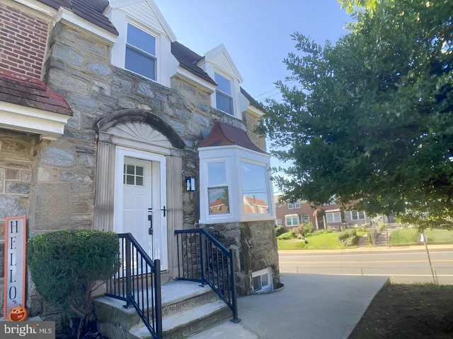 a view of a house with a small yard and swimming pool
