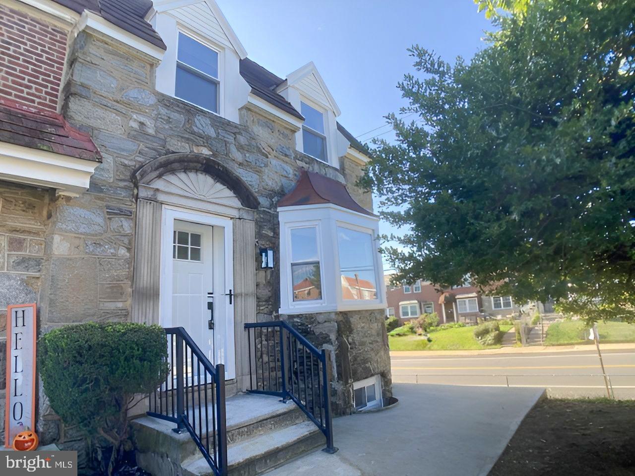 a view of a house with a small yard and swimming pool
