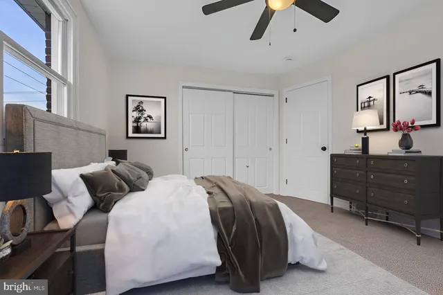 a bedroom with a bed and ceiling fan