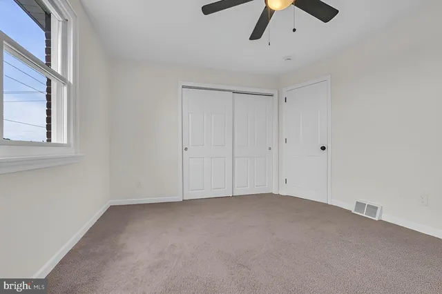 a view of room and chandelier fan
