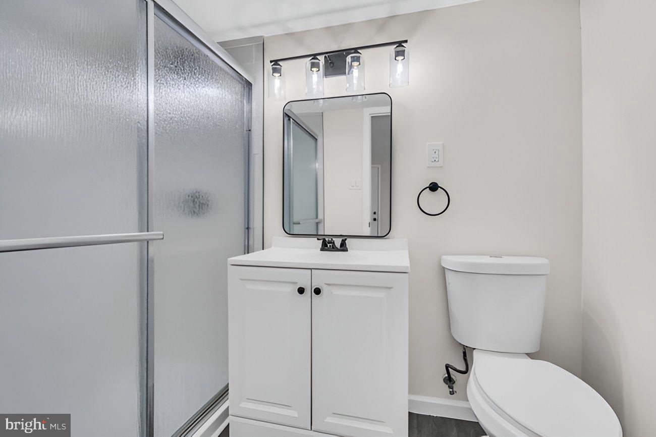 1300 East Sharpnack Street Philadelphia, PA 19150 - Photo 23 of 31 a bathroom with a toilet a sink and mirror