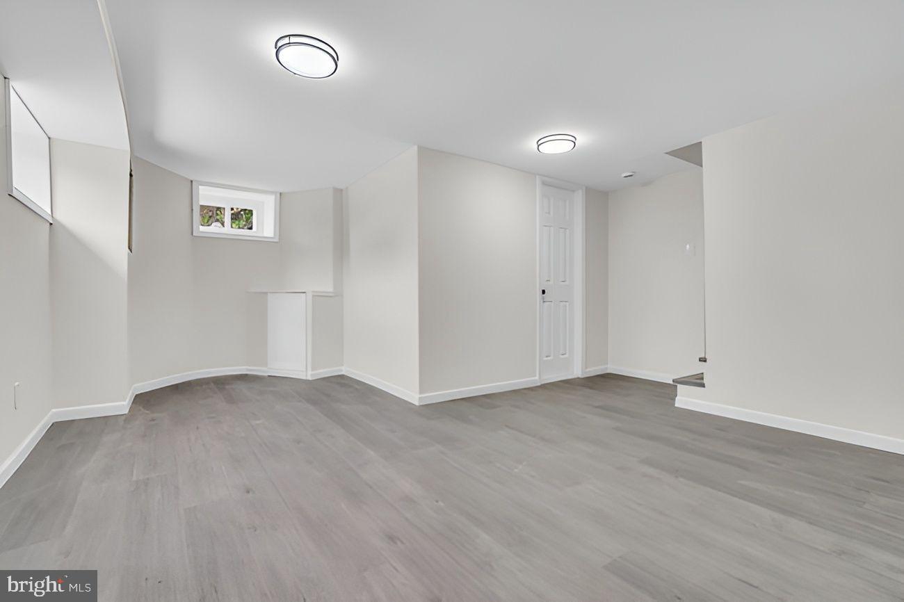 1300 East Sharpnack Street Philadelphia, PA 19150 - Photo 26 of 31 an empty room with wooden floor and windows