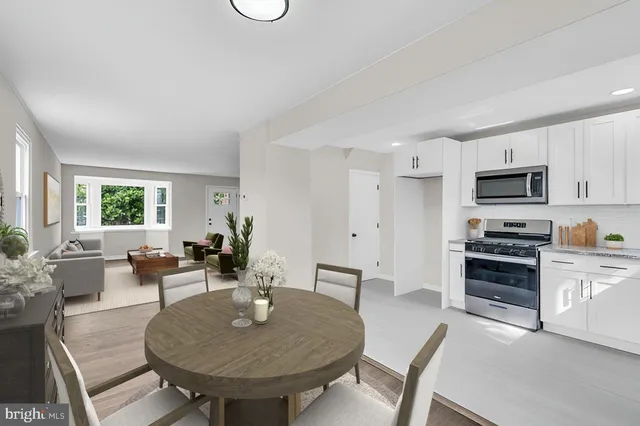a view of kitchen with sink dining table and chairs