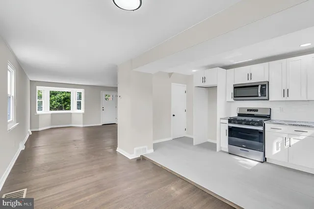 a view of a kitchen with dishwasher and a stove top oven