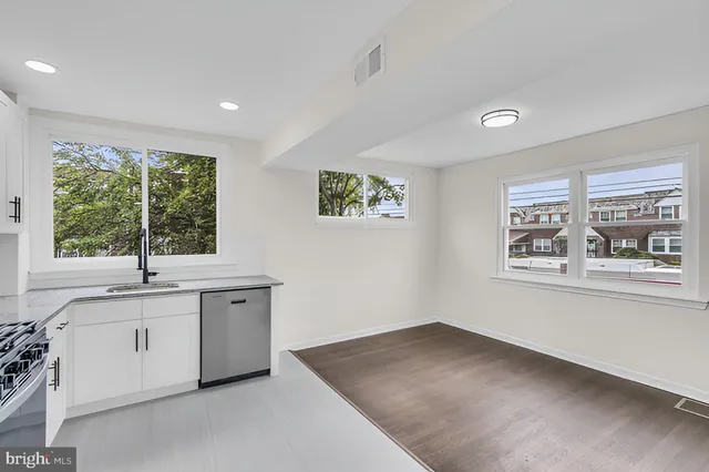 a view of cabinets a sink and a window in a room