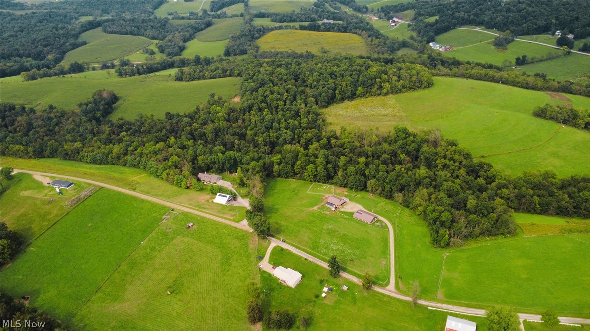 212 Township Road Fresno, OH 43824 - Photo 4 of 50 Expansive green acreage with rolling topography, mature tree lines, and multiple structures