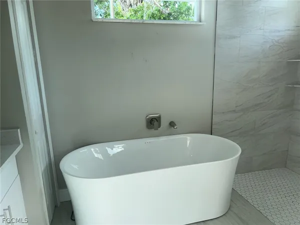 a white bath tub sitting in a bathroom