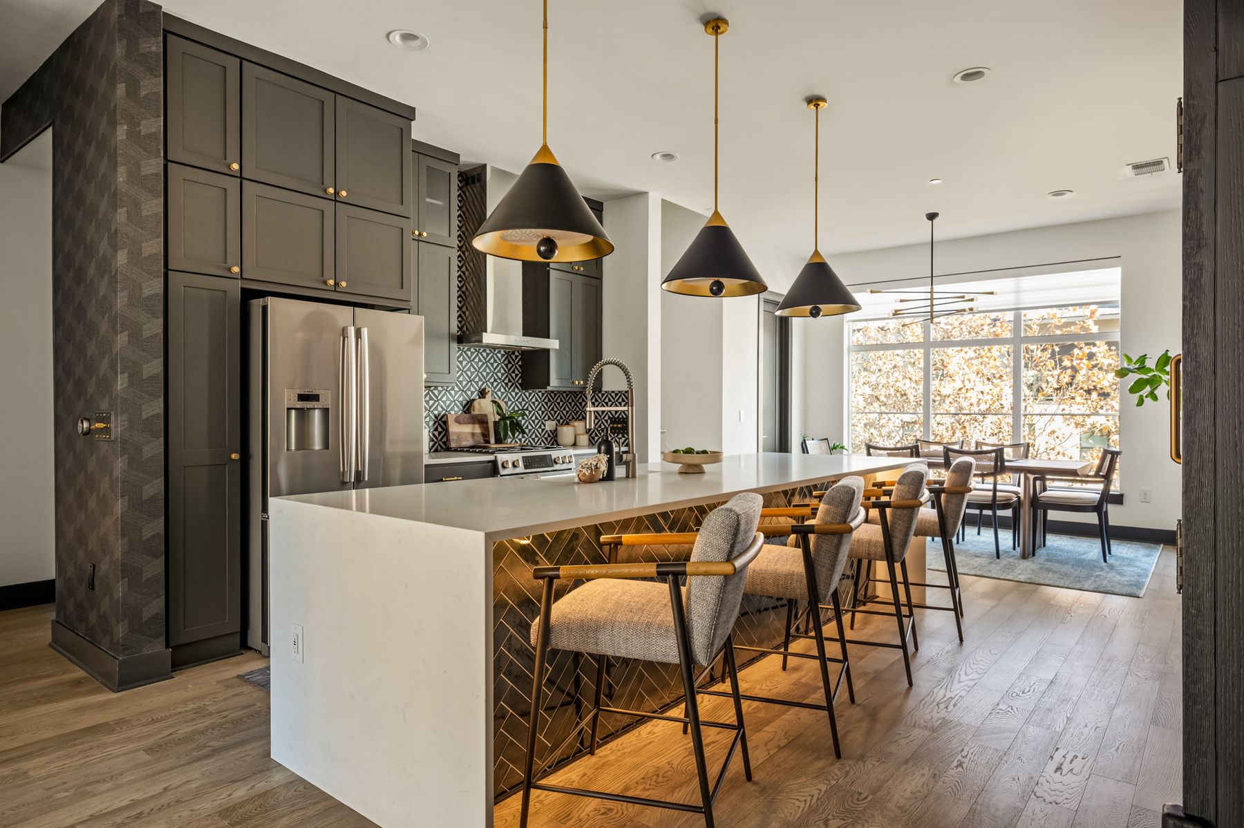 4507 Unity Circle Austin, TX 78731 - Photo 17 of 39 a kitchen with stainless steel appliances granite countertop a stove a refrigerator a kitchen island a dining table and chairs with wooden floor