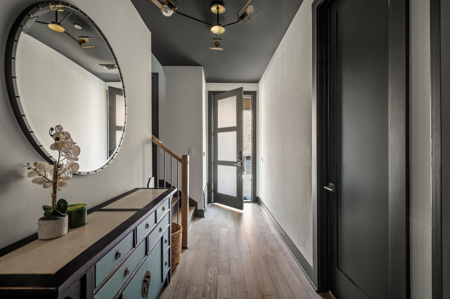 4507 Unity Circle Austin, TX 78731 - Photo 4 of 39 a hallway with wooden floor stairs and wooden floor