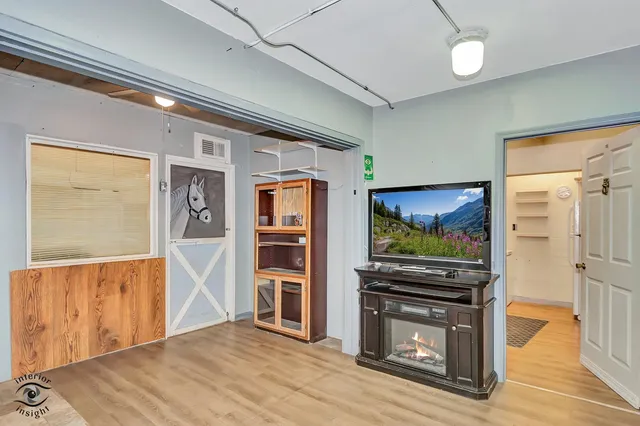 a living room with furniture and large windows