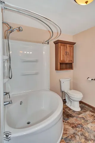 a bathroom with a toilet and a shower