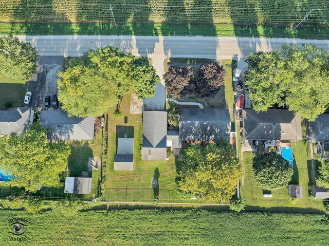 an aerial view of a house with a yard