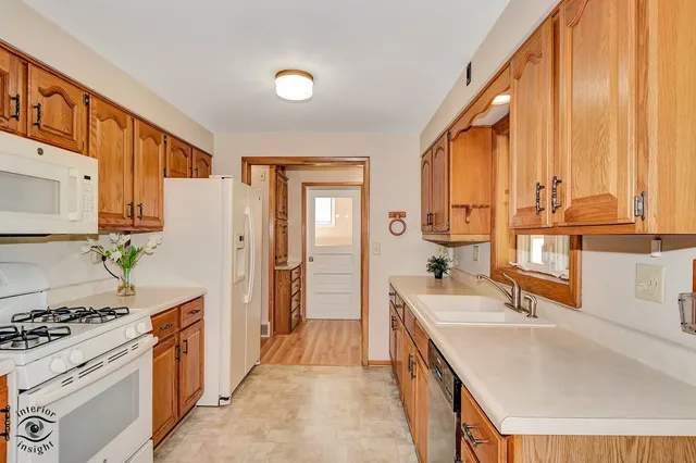 a kitchen with a sink stove and cabinets