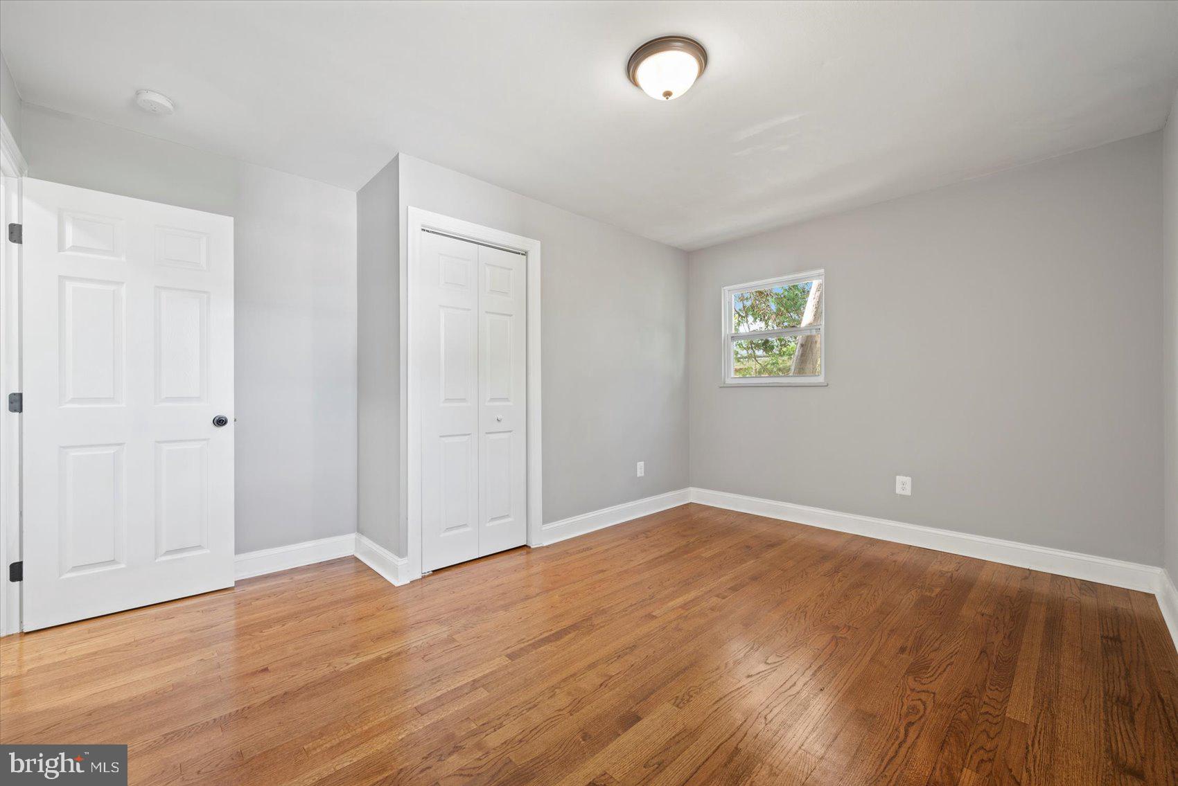 3107 Rheims Road Baltimore, MD 21244 - Photo 13 of 33 an empty room with wooden floor and windows