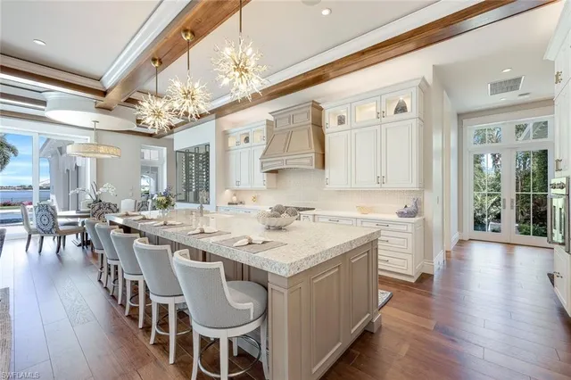 a kitchen with a center island wooden floor and stainless steel appliances