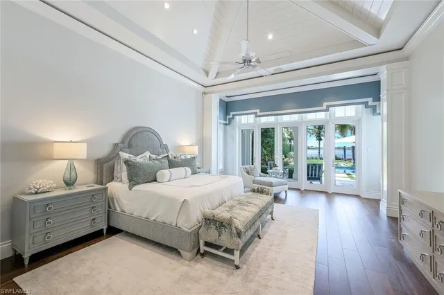 a bedroom with bed and wooden floor