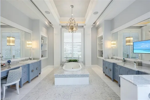 a spacious bathroom with a double vanity sink large mirror and a bathtub
