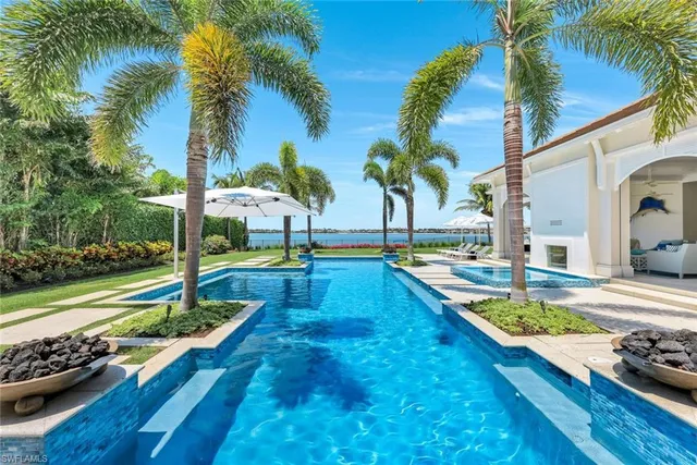 a view of a backyard with swimming pool