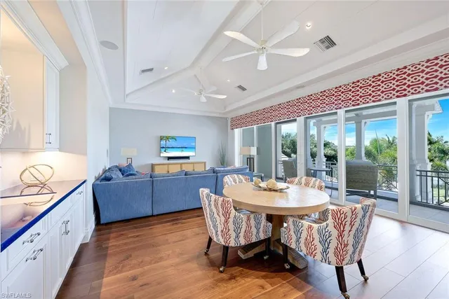 a dining room with furniture window and wooden floor