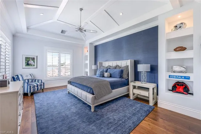 a spacious bedroom with a bed a couch and dresser