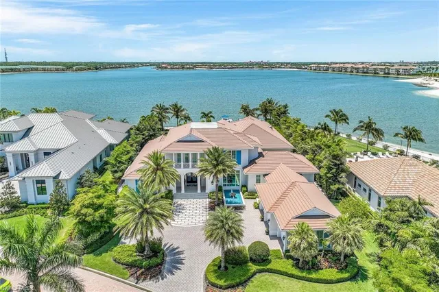 an aerial view of a house with outdoor space and lake view