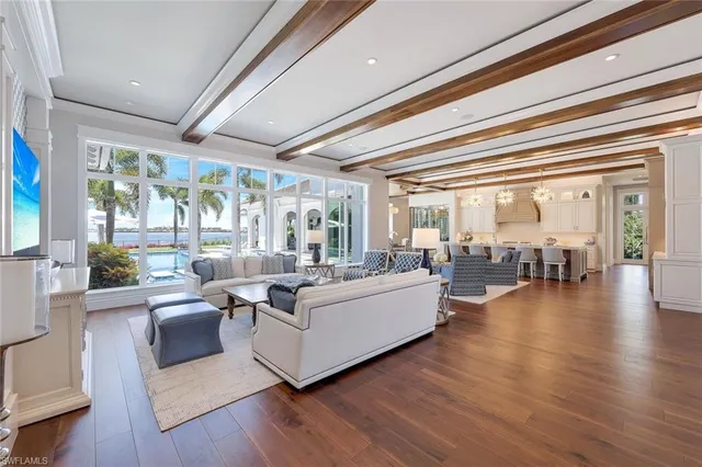 a living room with fireplace furniture and a large window