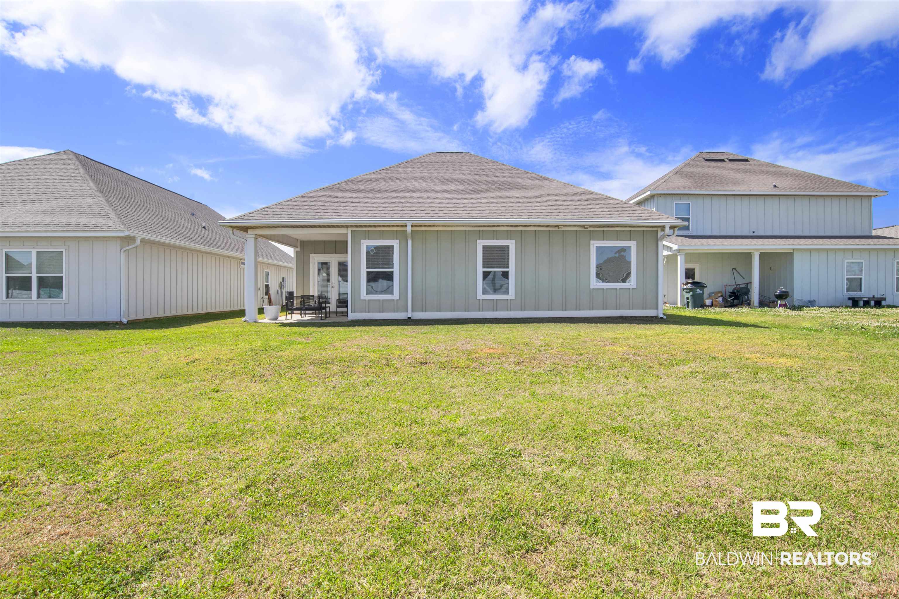24253 Alydar Loop Daphne, AL 36526 - Photo 39 of 44 Rear view of property with a patio, a yard, a shingled roof, and board and batten siding