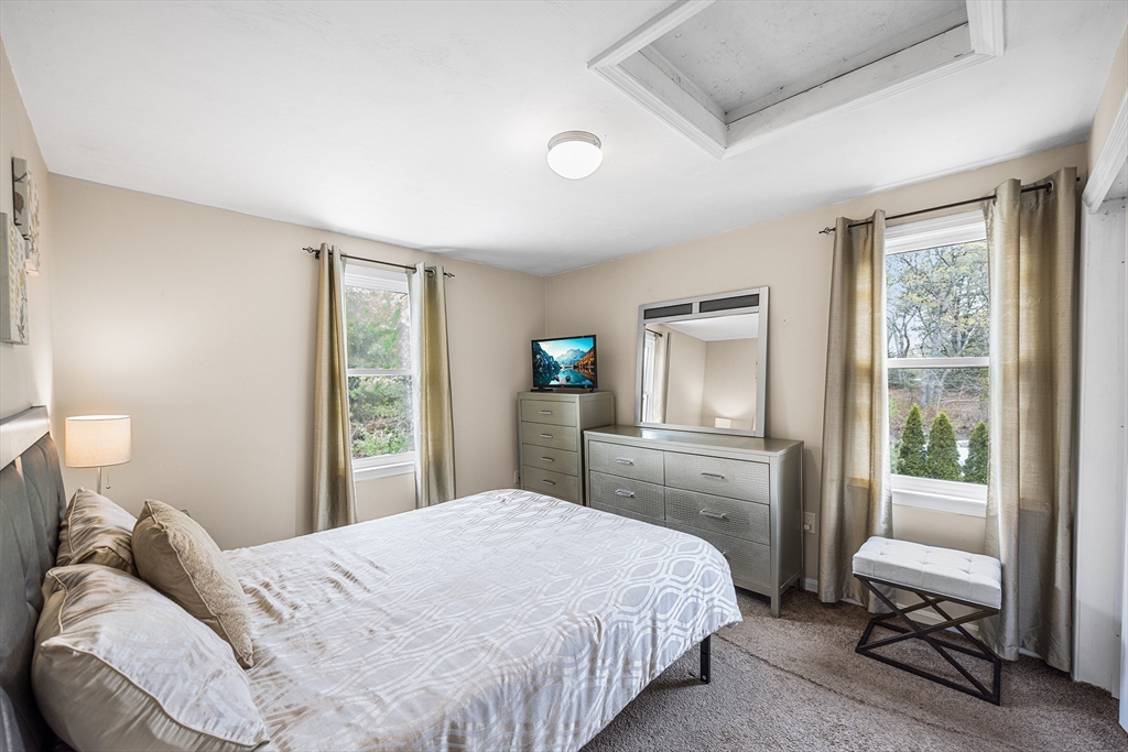 239 Upper County Road South Dennis, MA 02660 - Photo 16 of 38 a bedroom with a bed wooden floor and a window