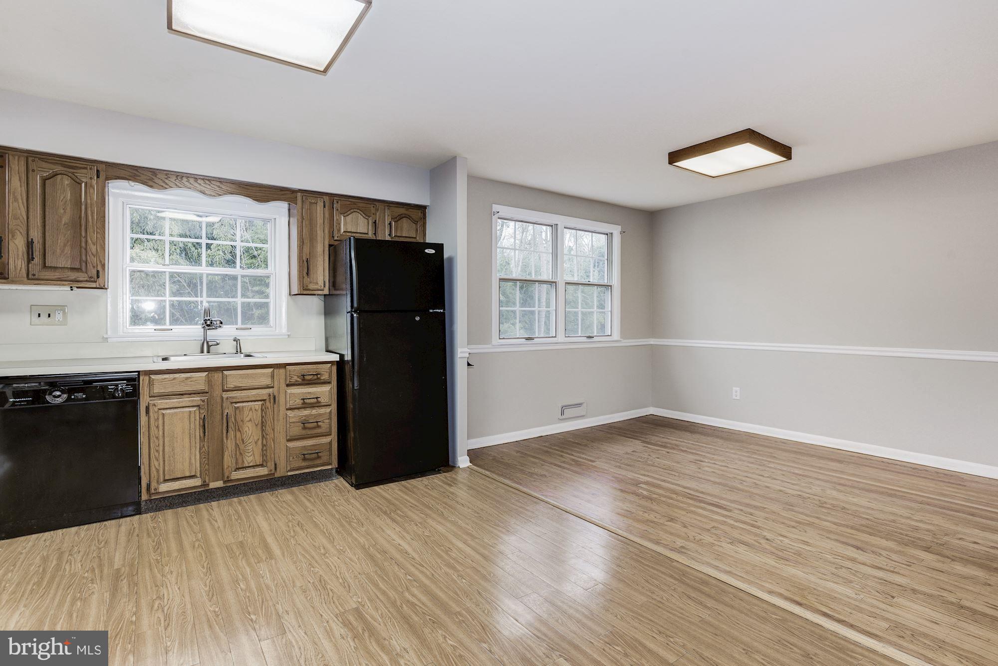 211 Winston Road Mount Laurel, NJ 08054 - Photo 15 of 32 an empty room with a kitchen island wooden floor and stainless steel appliances