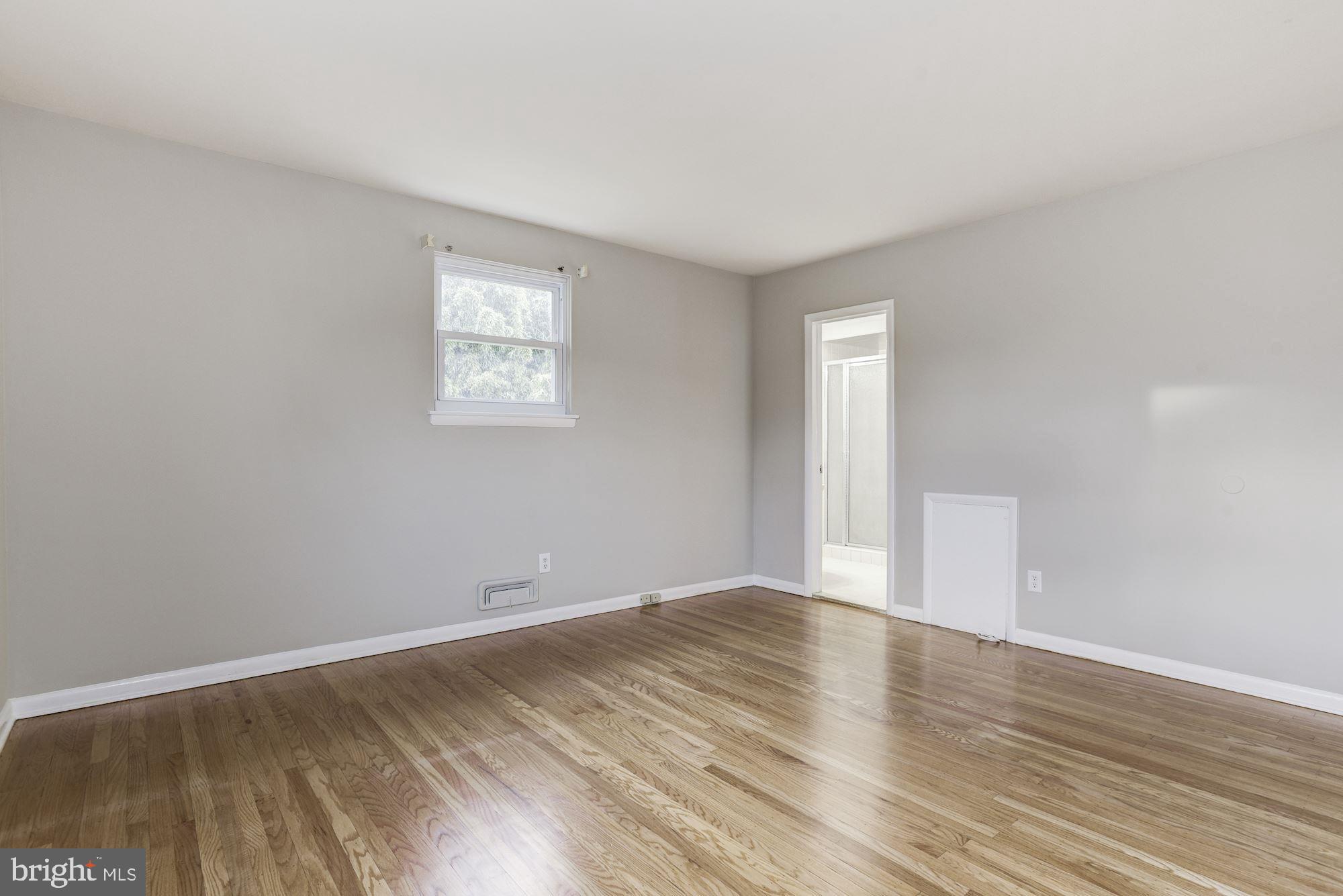 211 Winston Road Mount Laurel, NJ 08054 - Photo 17 of 32 a view of an empty room with wooden floor and a window