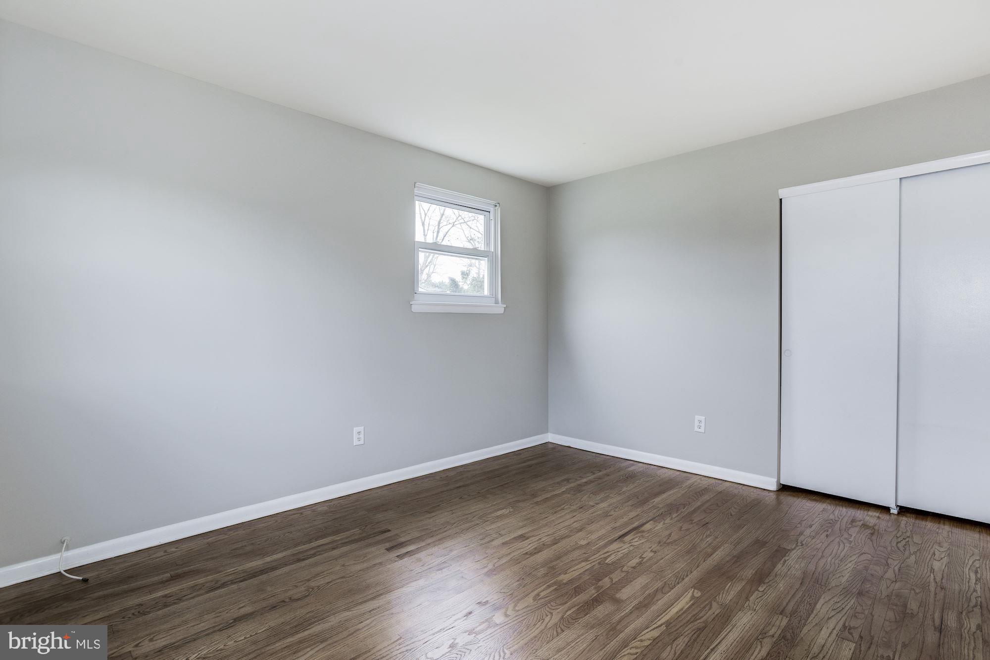 211 Winston Road Mount Laurel, NJ 08054 - Photo 20 of 32 a view of an empty room with wooden floor and a window
