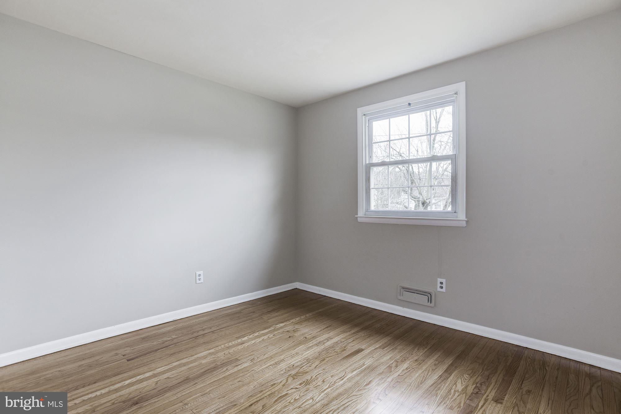 211 Winston Road Mount Laurel, NJ 08054 - Photo 21 of 32 an empty room with wooden floor and windows