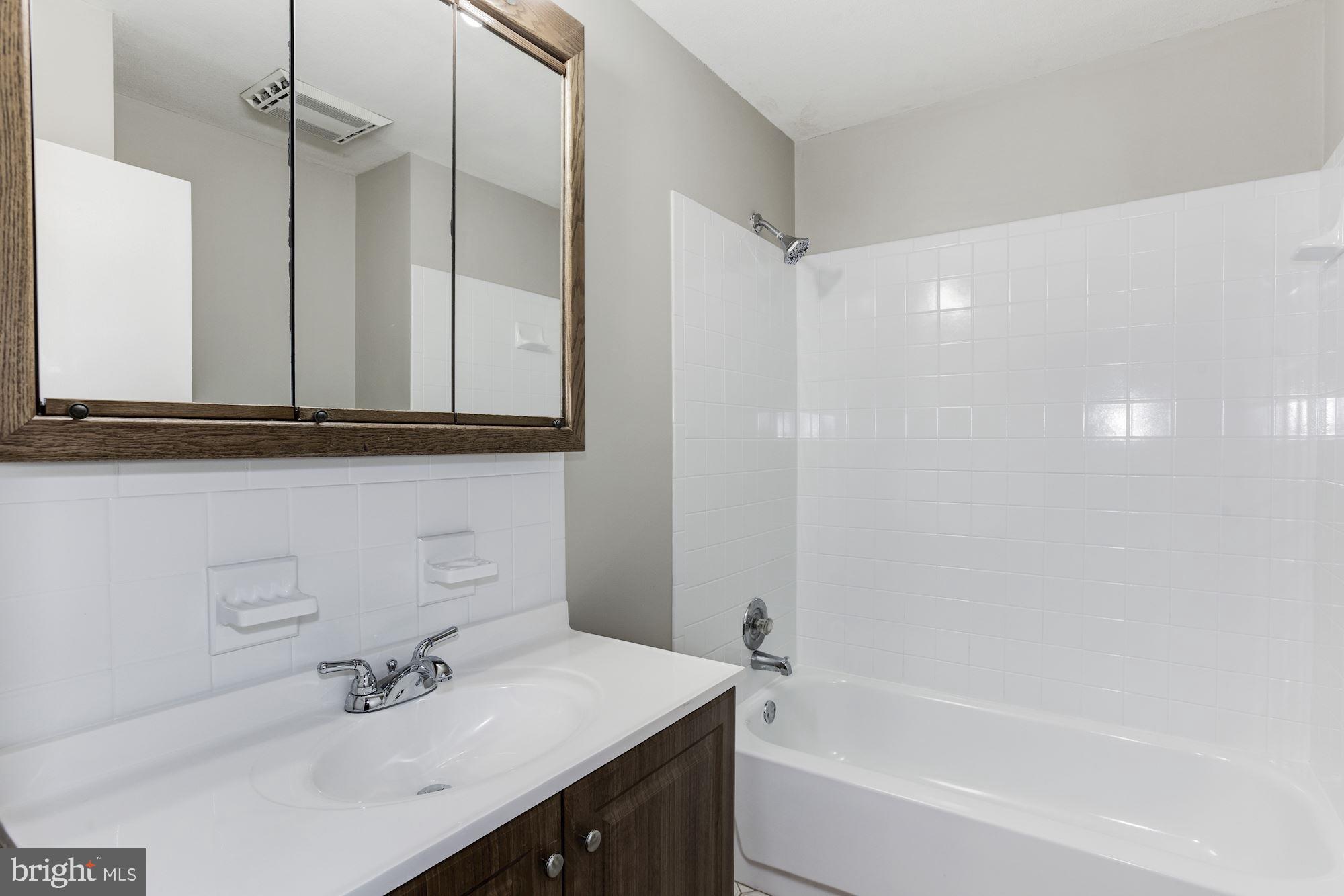 211 Winston Road Mount Laurel, NJ 08054 - Photo 23 of 32 a bathroom with a bathtub shower sink vanity and mirror