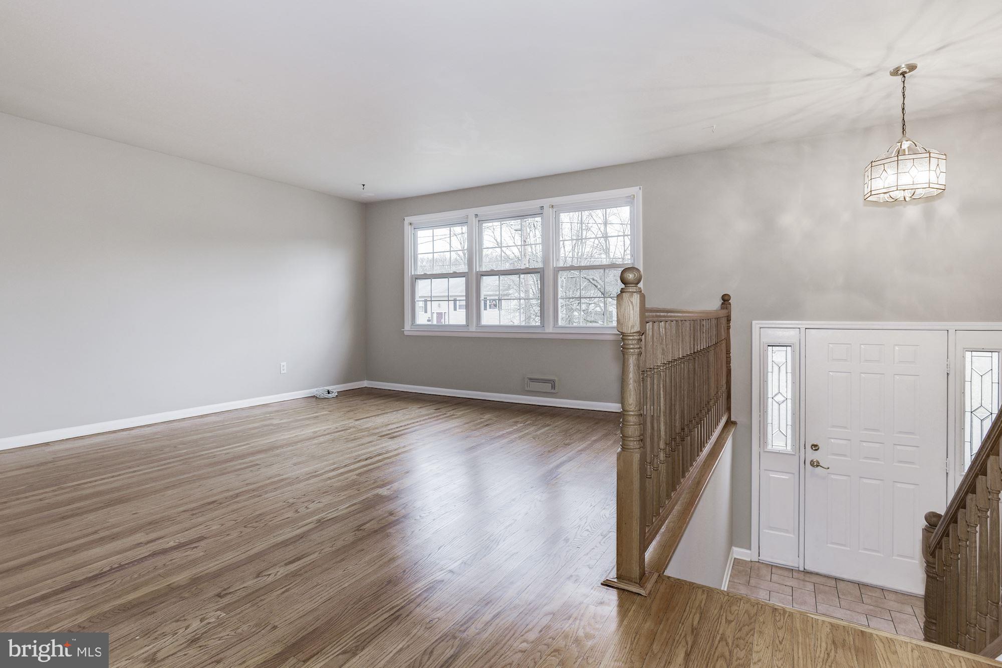 211 Winston Road Mount Laurel, NJ 08054 - Photo 4 of 32 an empty room with wooden floor and windows