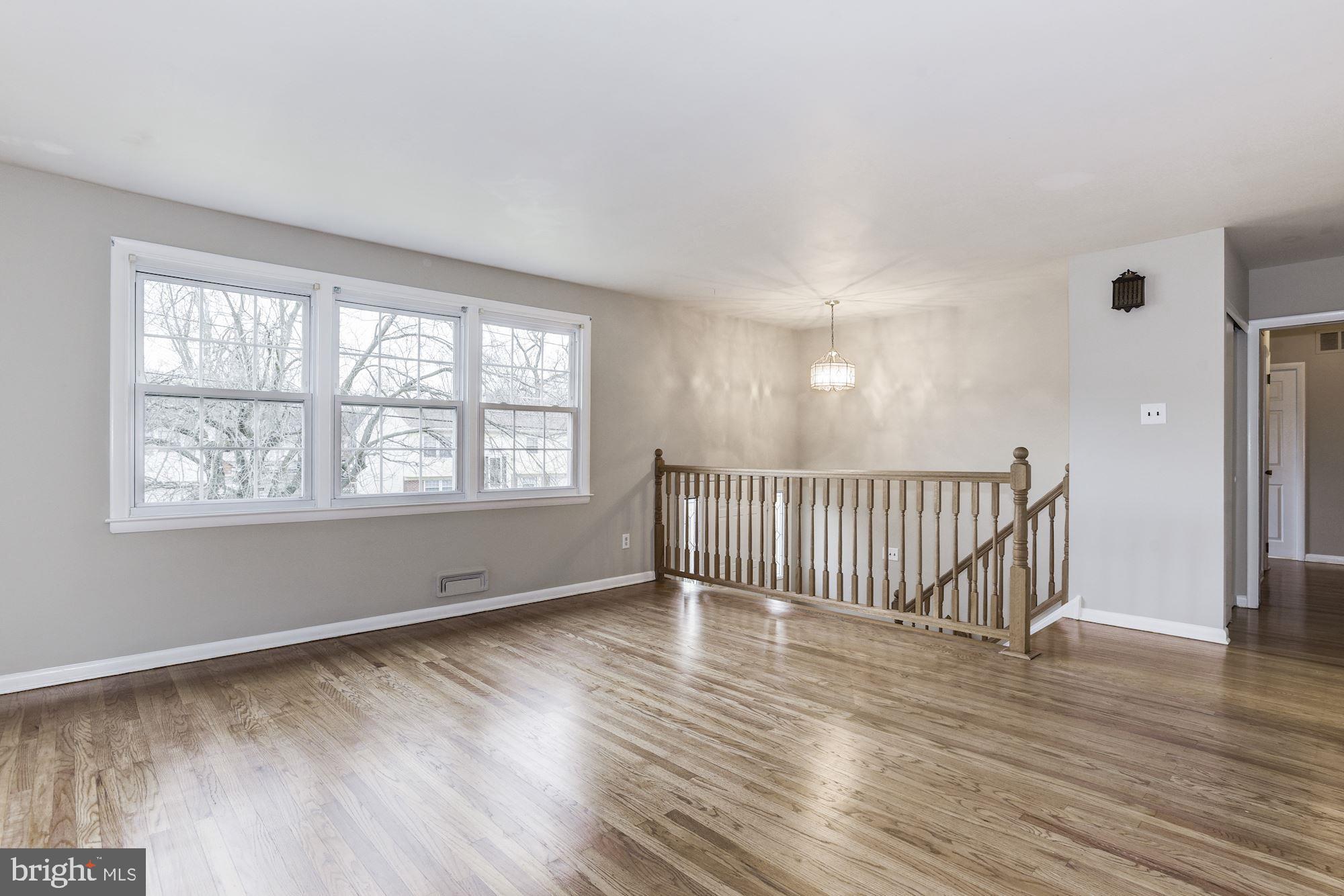 211 Winston Road Mount Laurel, NJ 08054 - Photo 6 of 32 a view of an empty room with wooden floor and a window